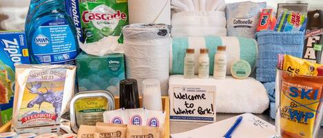 A variety of toiletries and amenities including Dawn dish soap, Cascade toilet paper, and various personal care products.