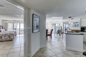 Enjoy a spacious room with a large bed, dining area, and kitchenette, perfect for a comfortable stay.