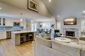 Relax in a comfortable living area with a sofa, armchairs, and fireplace.