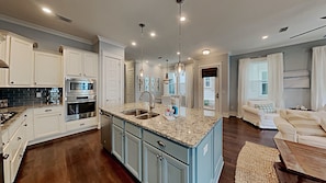 Enjoy cooking in this well-equipped kitchen with a central island, oven, and ample workspace.