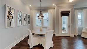 Enjoy meals in this stylish dining area with a round table and comfortable chairs.