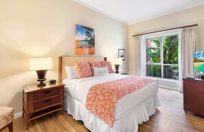A hotel room with a large bed, two bedside tables with lamps, a wooden nightstand, a desk with a computer, a window with curtains, and a painting on the wall.