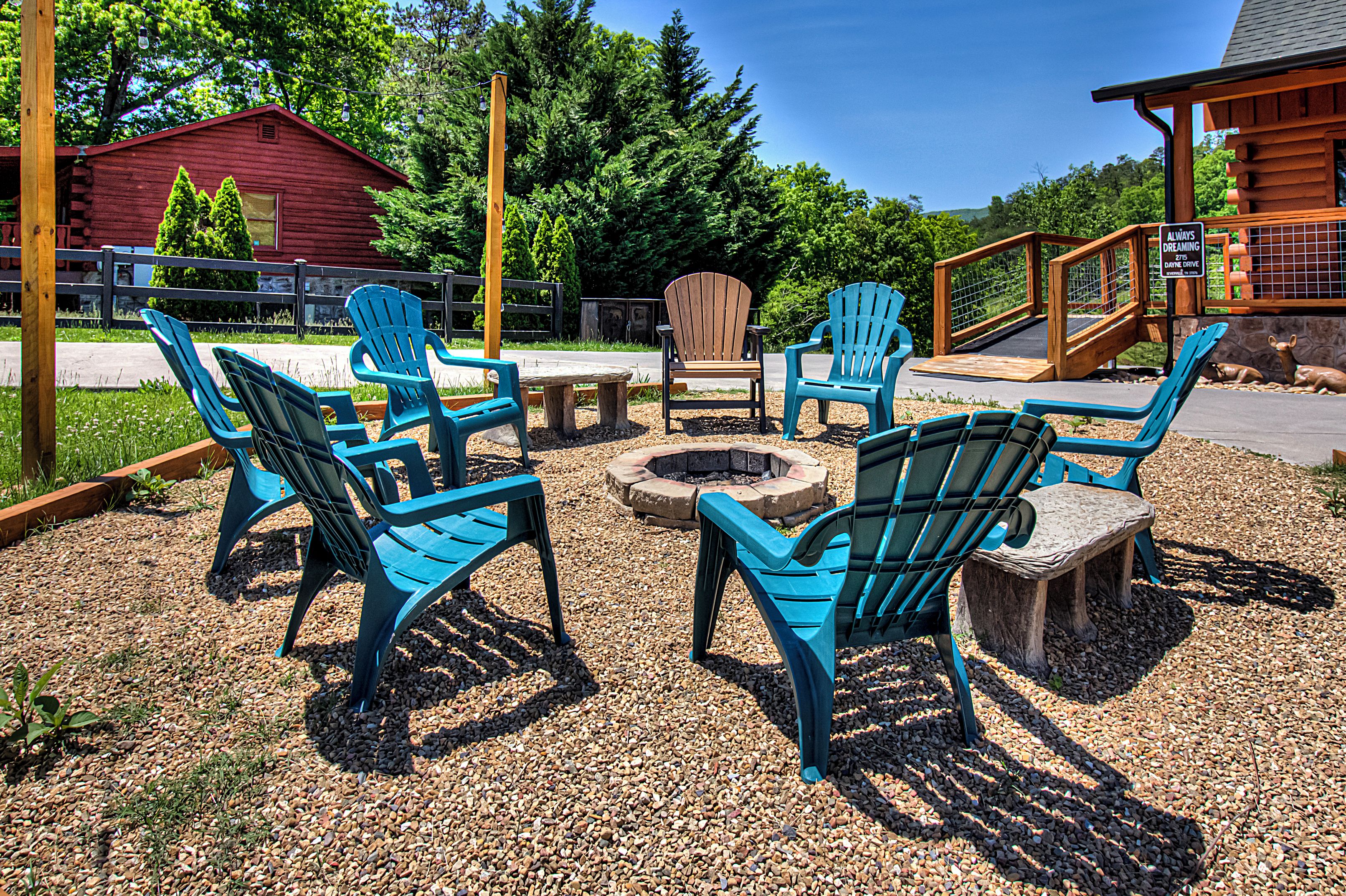 An outdoor seating area with Adirondack chairs and a fire pit.