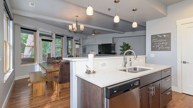 A modern kitchen with a large island, stainless steel appliances, and pendant lighting. - Best location in Salida! 2 River front decks, looks over Arkansas River waterpark! (Salida)