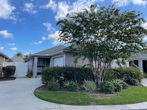 A residential house with a front yard, a driveway, and a garage.