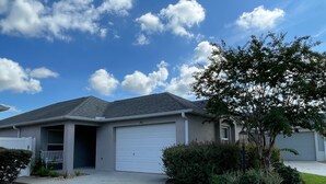 A residential house with a garage, a covered porch, and a well-maintained lawn. - Your Private Slice of Paradise Near Brownwood! (The Villages)