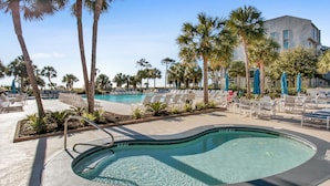 A pool area with lounge chairs and palm trees. - Shorewood 312 -  3 bedroom Beautiful Ocean Front (Hilton Head Island)
