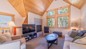 A cozy living room with a fireplace, television, and comfortable seating.