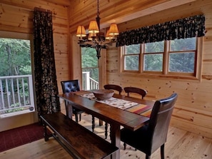 Enjoy meals in the dining area with a large table and comfortable seating for four.