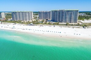 A beachfront hotel with multiple high-rise buildings, a sandy beach, and clear turquoise waters. - Fully equipped, open-concept condo w/private balcony! 🌴 (Destin)
