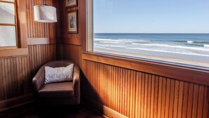 A wooden room with a view of the ocean.