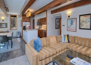 Relax in this inviting living space with a cozy sofa, coffee table, and dining area.