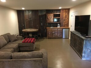 Relax in this cozy living space with a sectional sofa and round coffee table, perfect for unwinding.