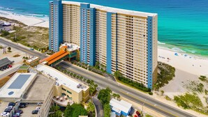 A high-rise hotel with multiple floors, a parking garage, and a beach view. - BEACHFRONT UNIT!! COMFORTABLY SLEEPS 8! UPDATED JUNE 2026!! (Panama City Beach)