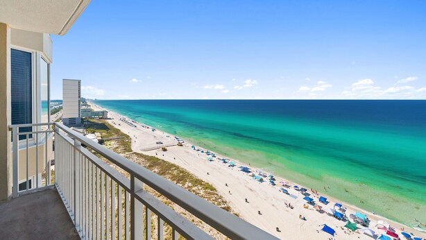A balcony with a view of a beach, clear turquoise water, and a clear sky. - BEACHFRONT UNIT!! COMFORTABLY SLEEPS 8! UPDATED JUNE 2026!! (Panama City Beach)