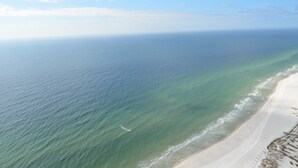 A beach with clear water and a sandy shore. - Oasis, Formerly Phoenix West II, Beach front, Lazy River/Water Slide!! (Orange Beach)