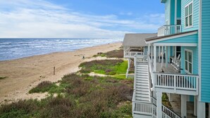 A beachfront property with a balcony overlooking the ocean. - Front Row | Pet-Friendly, Stunning Beach Views (Galveston)
