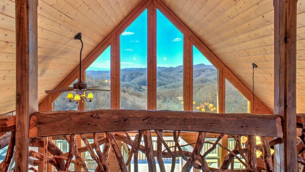 A wooden interior with a sloped ceiling and large windows offering a view of a mountainous landscape. - Ski-In Views & Hot Tub⛷️ Black Bear Lodge + 8 mins to Hatley Pointe (Mars Hill)