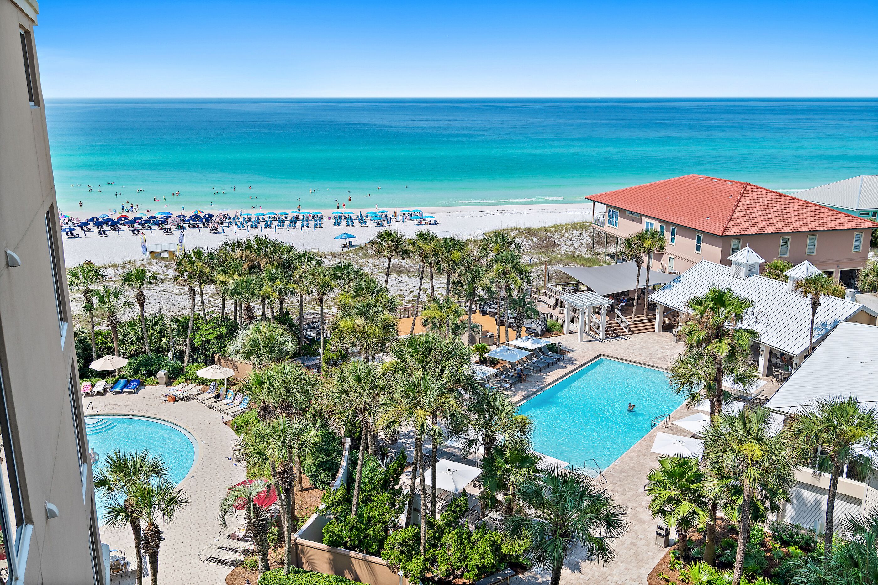 A resort with a pool, beach, and ocean view.