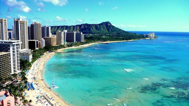 A coastal cityscape with a beach, high-rise buildings, and a mountain in the background. - Bamboo Hotel - Privately owned Queen Studio - Balcony, Steps to Waikiki Beach (Waikiki)