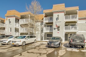 Classic residential building with a symmetrical facade and balconies on each floor, offering parking and a patriotic theme.