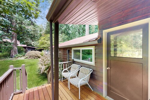 Tranquil landscape with riverside firepit, gas grill, gas fireplace, and deck