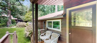 Tranquil landscape with riverside firepit, gas grill, gas fireplace, and deck