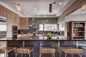 Enjoy meals and snacks at the central island with a stainless steel sink and a variety of appliances.