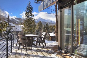Relax on the deck with a table and chairs, taking in the breathtaking views of the surrounding mountains.