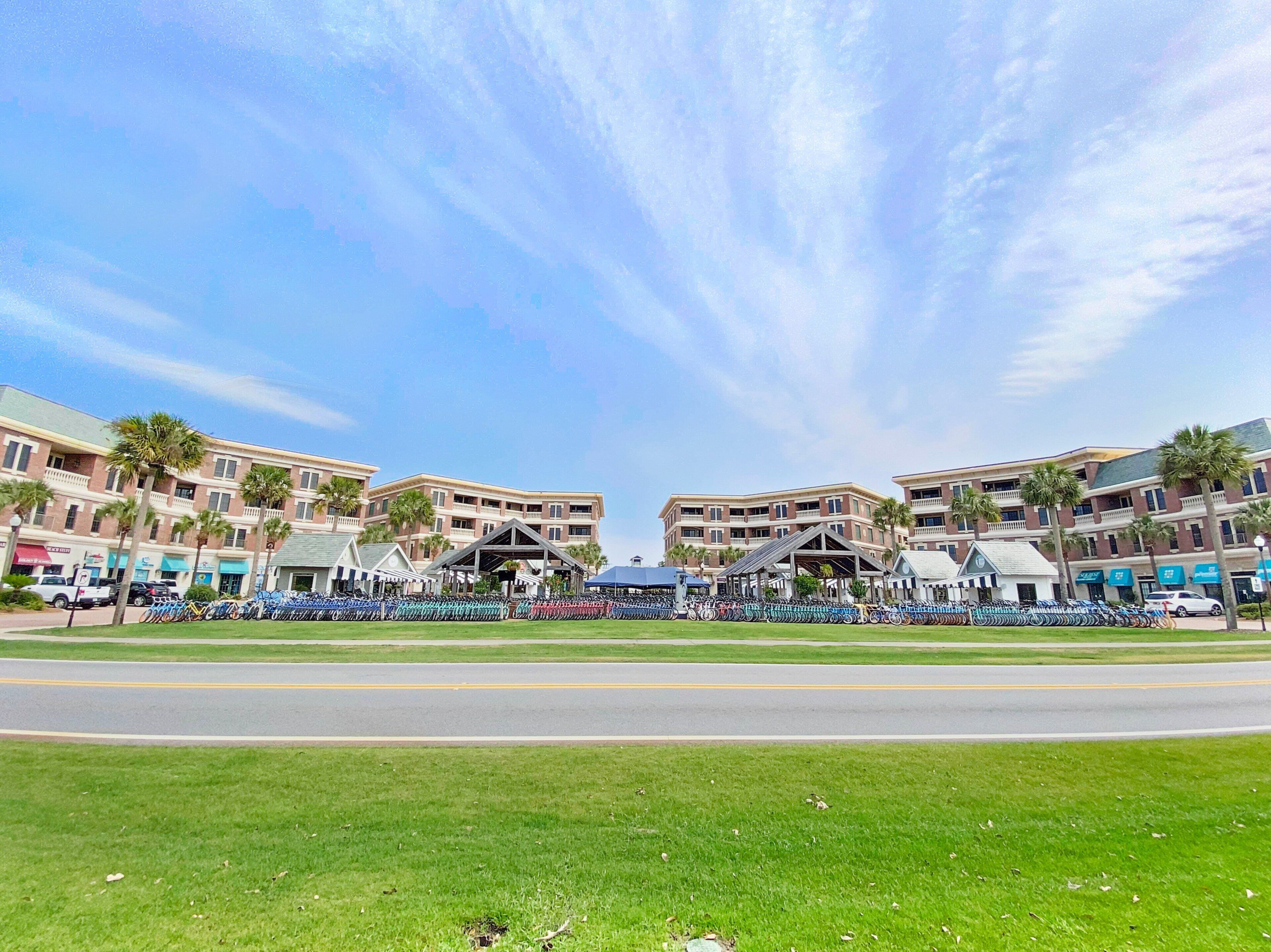 A hotel with a central courtyard, multiple floors, and a parking area.