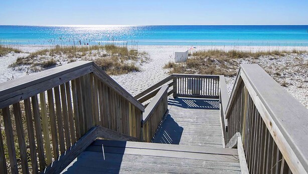 A wooden boardwalk leading to a beach with clear blue water. - Gulfview II 101 | Ground Floor • 100 Steps to Beach • Free Beach Service • Sleep (Destin)