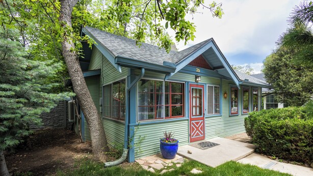 A house with a blue exterior, a red door, and a large window. - Beautiful Cheyenne Cañon Retreat with Hot Tub, Walk To Broadmoor Hotel & Trails. (Colorado Springs)