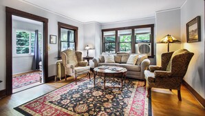 A living room with a sofa, armchairs, a coffee table, and a patterned rug. - Beautiful Cheyenne Cañon Retreat with Hot Tub, Walk To Broadmoor Hotel & Trails. (Colorado Springs)