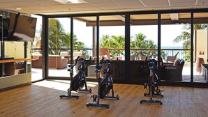 A gym with stationary bikes, large windows, and a view of the ocean. - Spectacular Diamond Head and Ocean Views! Free Valet Parking, Wi-Fi, Pool! (Honolulu)