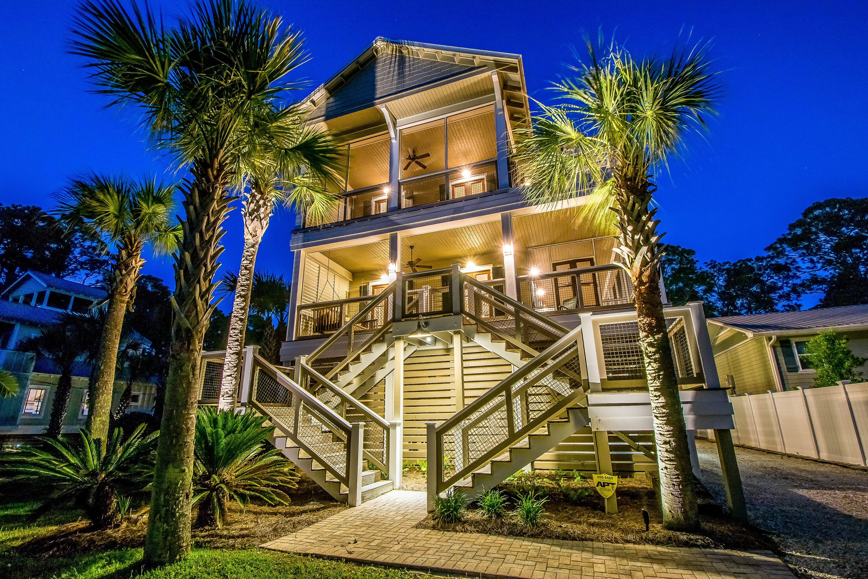 A multi-story house with a balcony and a staircase leading to the upper floor.