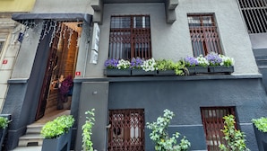 A multi-story hotel with a modern facade, large windows, and a red carpet at the entrance. -  BİG URBAN STAY TAKSİM@WİTH SEA VİEW (Istanbul)