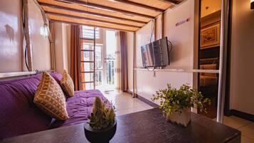 Deluxe Condo, 1 Bedroom, Kitchen, Mountain View | Living room | Flat-screen TV