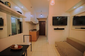Deluxe Condo, 1 Double Bed, Mountain View | Living room | Flat-screen TV - Moldex Residences by Tripsters Hub (Baguio)