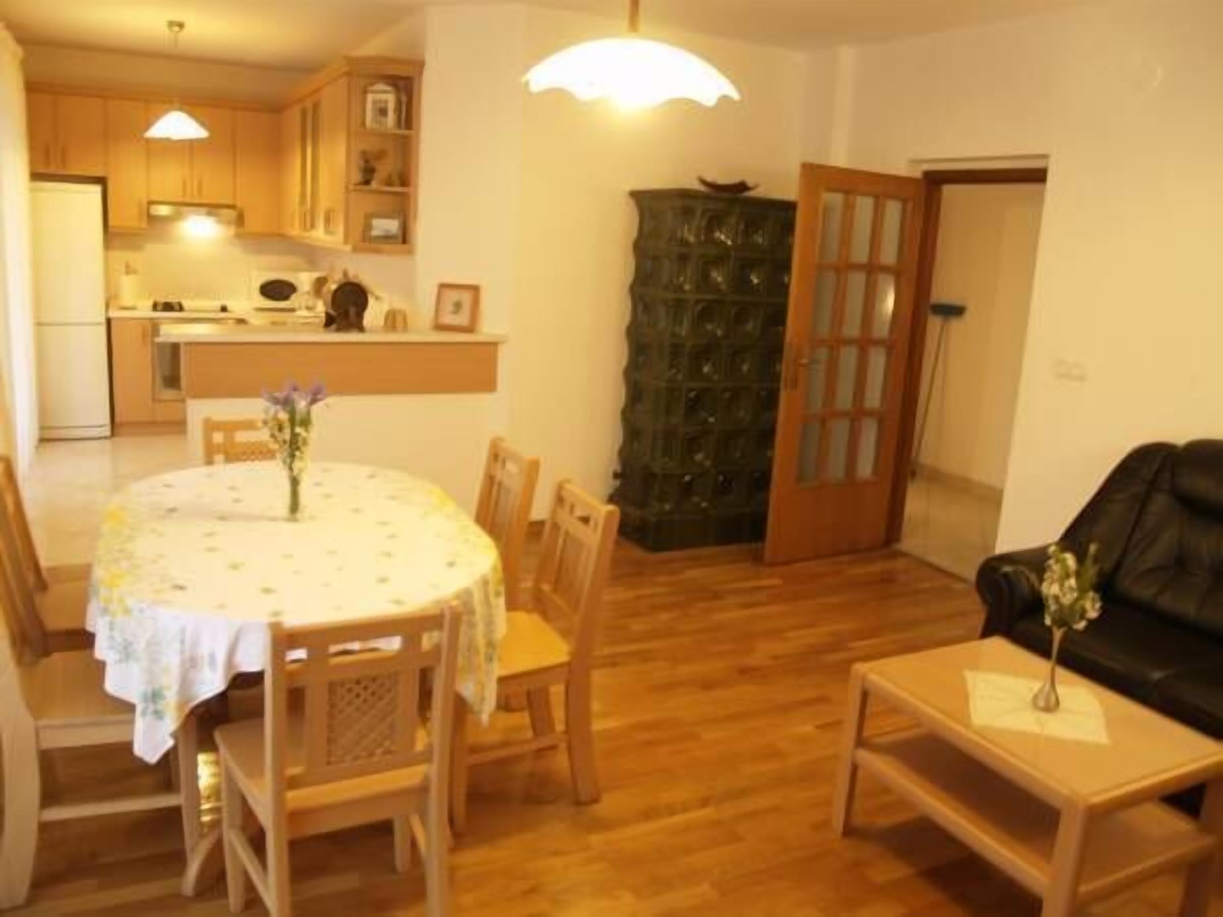 A compact living space with a dining area, kitchen, and a seating area.