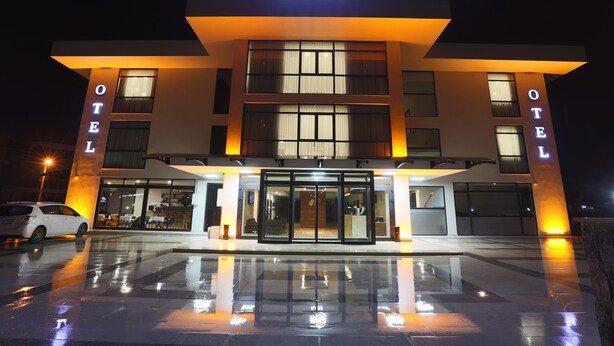 The exterior of the Carissa Hotel with a modern design, featuring a prominent entrance and a well-lit facade. - Carissa Hotel (Mugla)