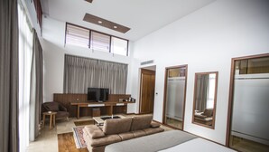 A modern hotel room with a large bed, a sofa, a TV, a desk, and a wardrobe. - Carissa Hotel (Mugla)