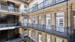 A multi-story building with balconies, staircases, and large windows. - Real Apartments Zichy (Budapest)
