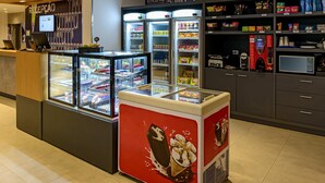 A food kiosk with ice cream displays and a refrigerated beer cooler. - ibis budget Foz Do Iguacu (Foz do Iguaçu)