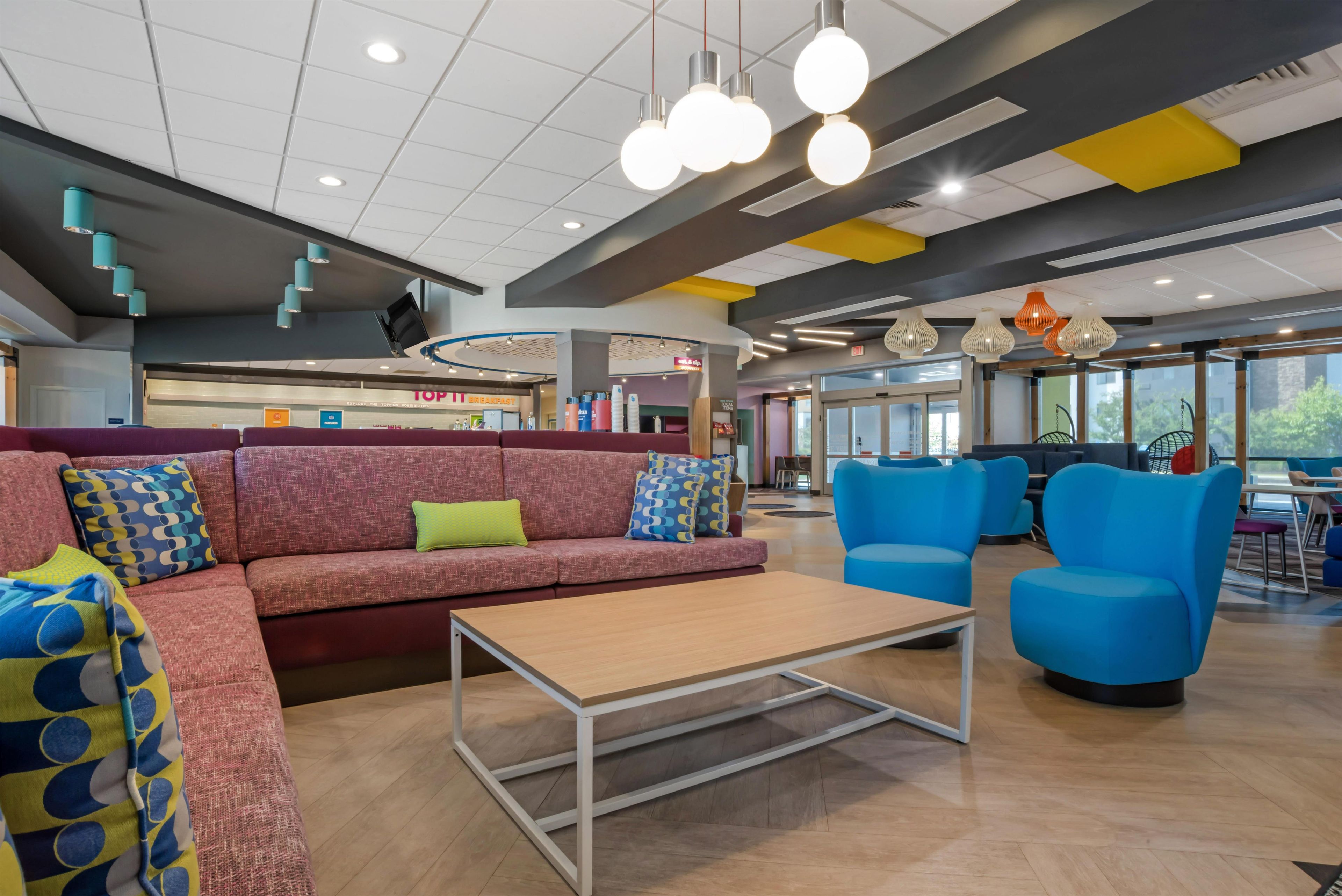 A modern lounge area with a sofa, chairs, and a coffee table.