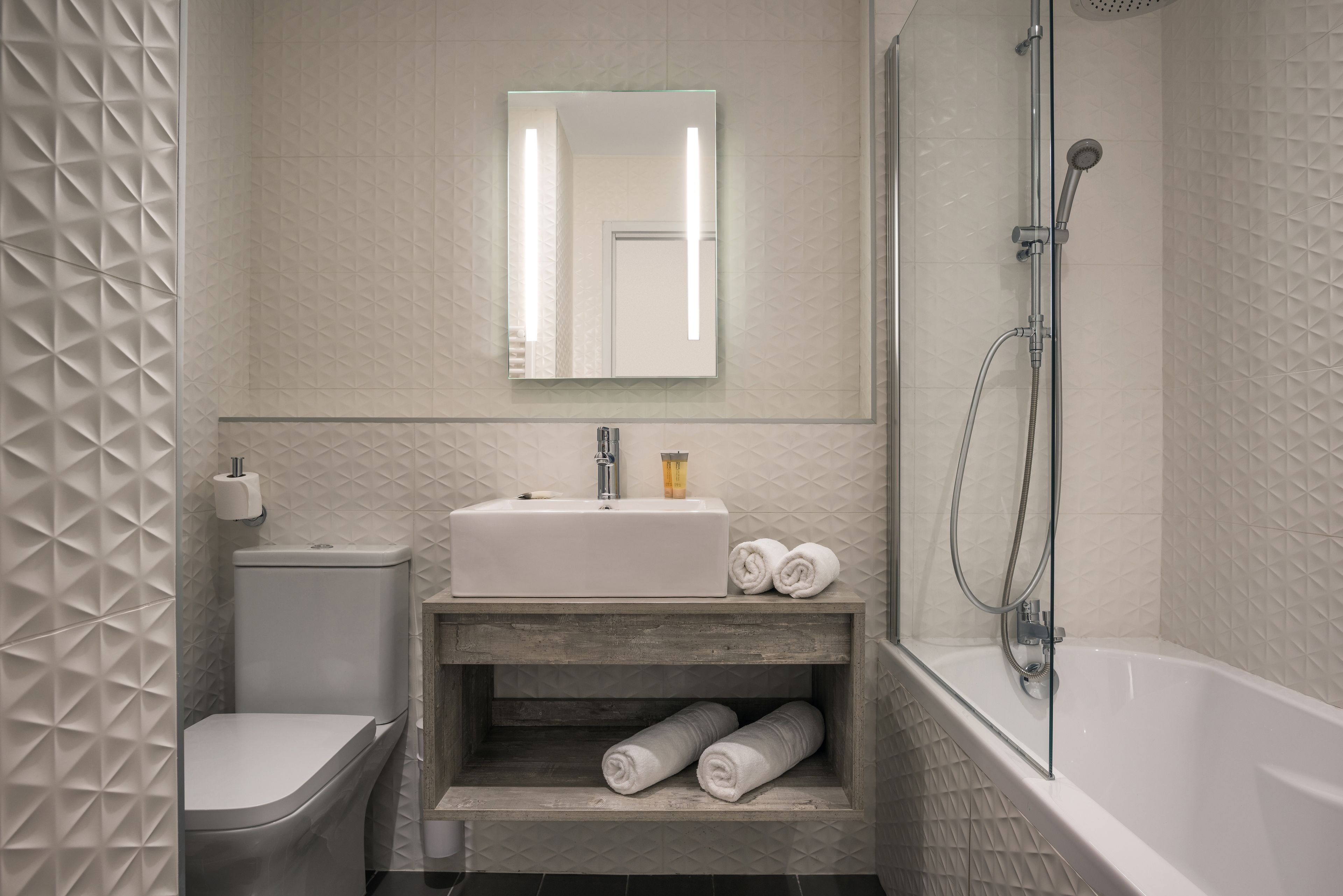 Un bagno con WC, lavandino e doccia.