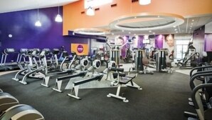 A gym with various exercise equipment, including treadmills and weight machines, arranged in a spacious layout. - Bianca's House Hotel Heathrow Airport (Slough)