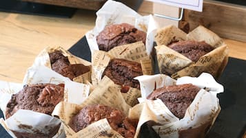A tray of brownies wrapped in paper with text, placed on a wooden surface.