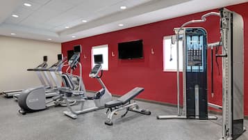 A gym with treadmills, an elliptical, and a weight machine.