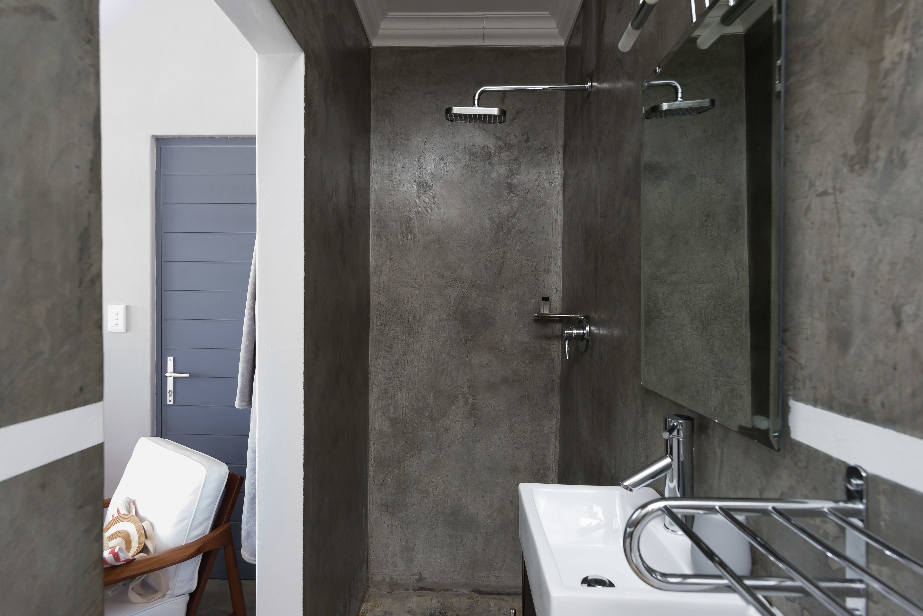 A bathroom with a shower, a sink, and a mirror.