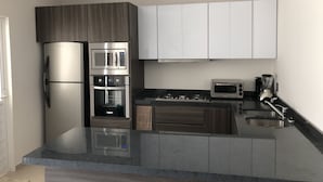 A modern kitchen with a built-in oven, microwave, and a coffee maker. - Villas del Santuario Rental Home (Ameca)